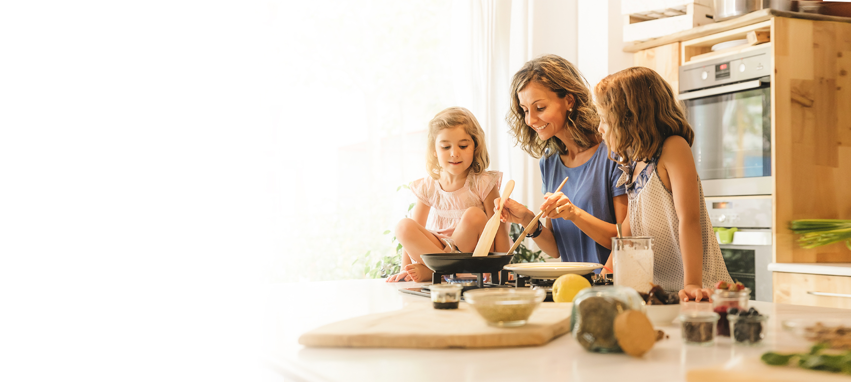 picute of a mother and her children cooking food.